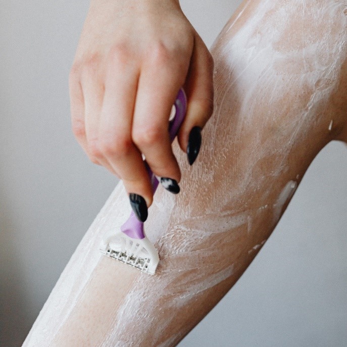 A person shaving her leg

Description automatically generated